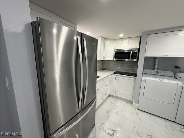1376 Archer St Unit 6, Lehigh Acres, FL 33936 - kitchen featuring appliances with stainless steel finishes, backsplash, marble finish floor, white cabinets, and washing machine and dryer