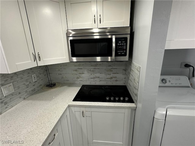 1376 Archer St Unit 6, Lehigh Acres, FL 33936 - kitchen featuring black electric cooktop, white cabinets, and stainless steel microwave
