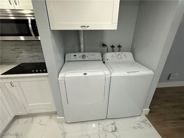 1376 Archer St Unit 6, Lehigh Acres, FL 33936 - laundry area featuring washing machine and clothes dryer, marble finish floor, baseboards, and cabinet space