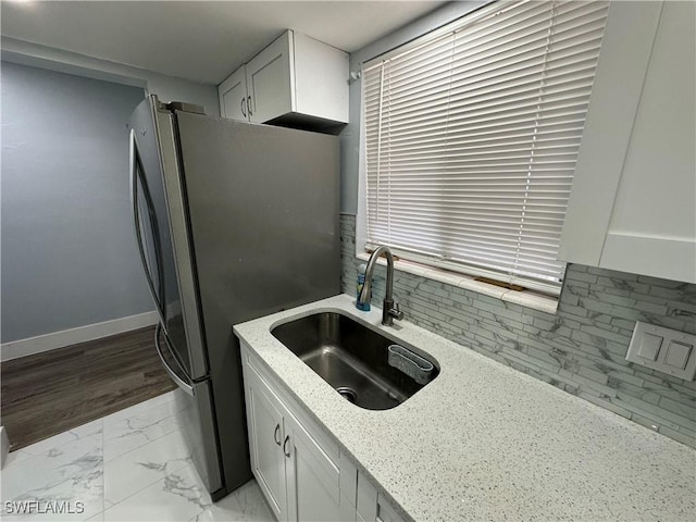 1376 Archer St Unit 6, Lehigh Acres, FL 33936 - kitchen featuring baseboards, marble finish floor, light stone countertops, a sink, and freestanding refrigerator