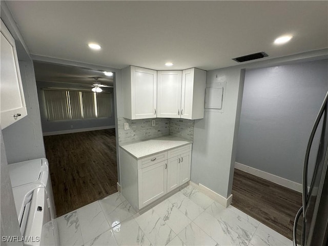 1376 Archer St Unit 6, Lehigh Acres, FL 33936 - interior space with white cabinetry, light countertops, decorative backsplash, marble finish floor, and visible vents