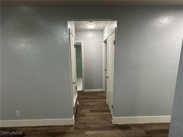 1376 Archer St Unit 6, Lehigh Acres, FL 33936 - hall with baseboards and dark wood finished floors