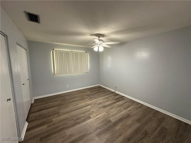 1376 Archer St Unit 6, Lehigh Acres, FL 33936 - unfurnished room featuring baseboards, dark wood finished floors, a textured ceiling, visible vents, and a ceiling fan