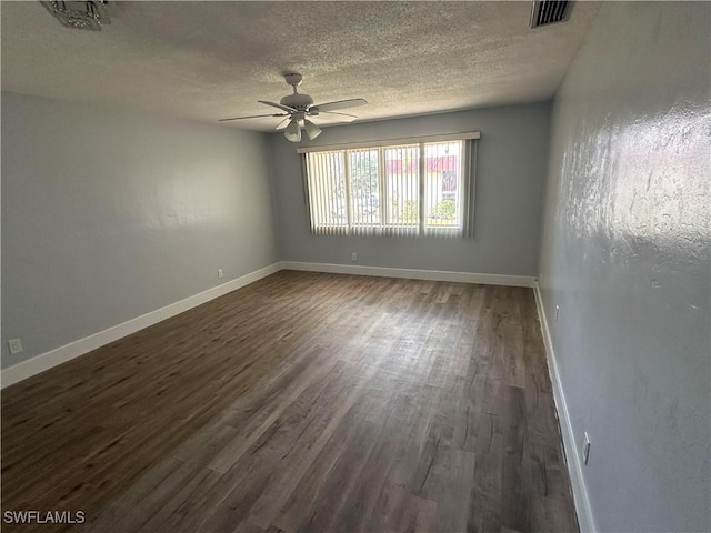 1376 Archer St Unit 6, Lehigh Acres, FL 33936 - empty room with a textured ceiling, visible vents, baseboards, ceiling fan, and dark wood finished floors