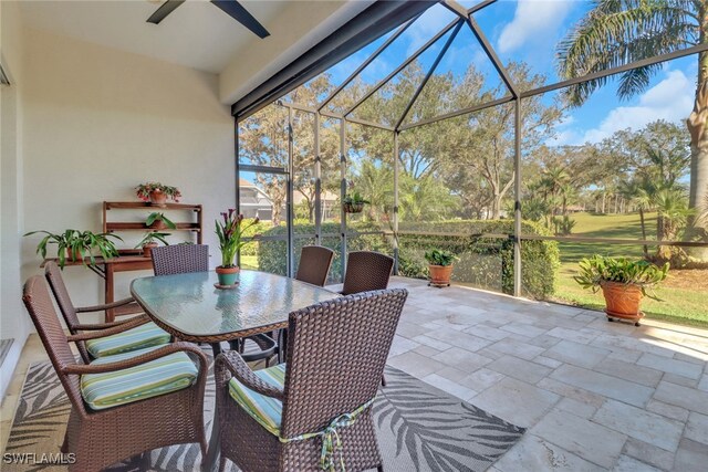 view of patio featuring a lanai and ceiling fan