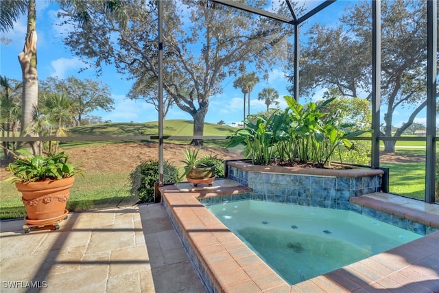 view of pool featuring a patio, an in ground hot tub, glass enclosure, and a lawn