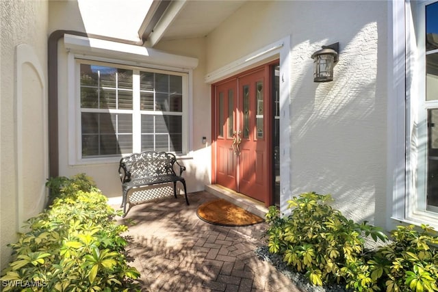 property entrance with stucco siding
