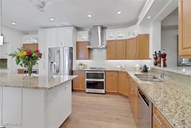 kitchen with tasteful backsplash, light wood-type flooring, wall chimney range hood, recessed lighting, and stainless steel appliances