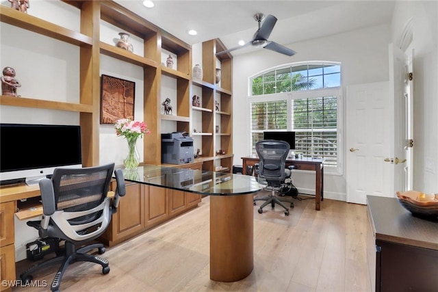 office featuring ceiling fan, recessed lighting, light wood-style floors, and built in shelves