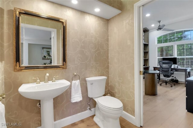 half bathroom featuring recessed lighting, baseboards, toilet, and wood finished floors