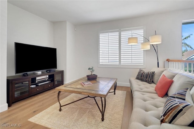 living room featuring light wood-type flooring and baseboards