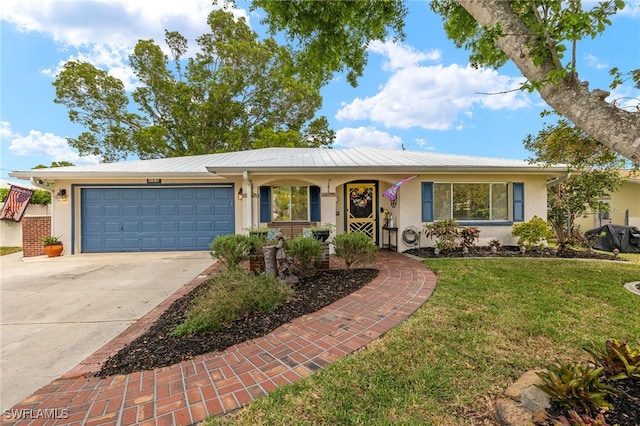 single story home featuring stucco siding, a garage, a front lawn, and concrete driveway