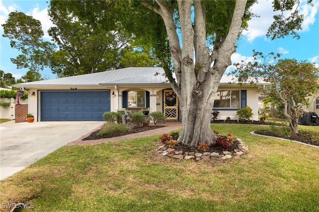 ranch-style home with a front yard, driveway, stucco siding, and an attached garage