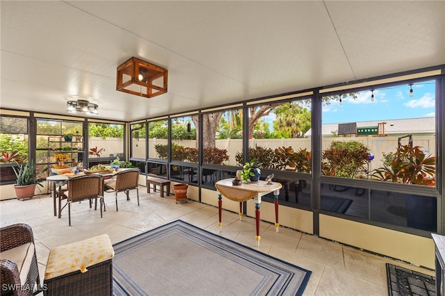 sunroom featuring outdoor dining space