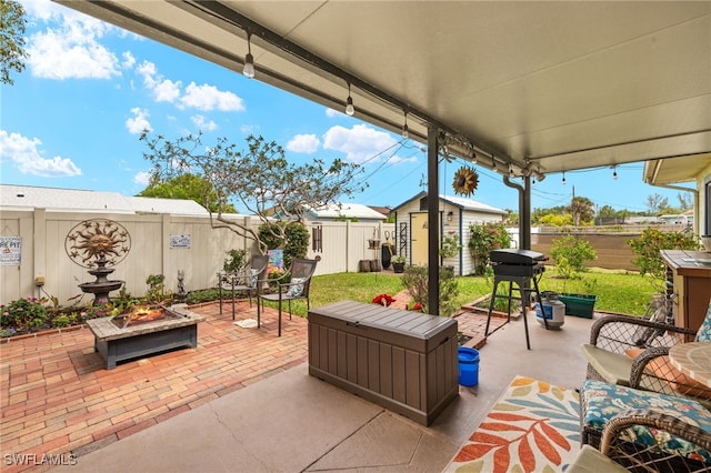 view of patio / terrace featuring an outdoor living space, an outdoor structure, a fenced backyard, and a storage shed