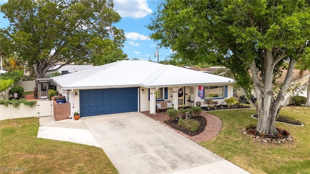 ranch-style house featuring fence, a garage, concrete driveway, a front lawn, and stucco siding