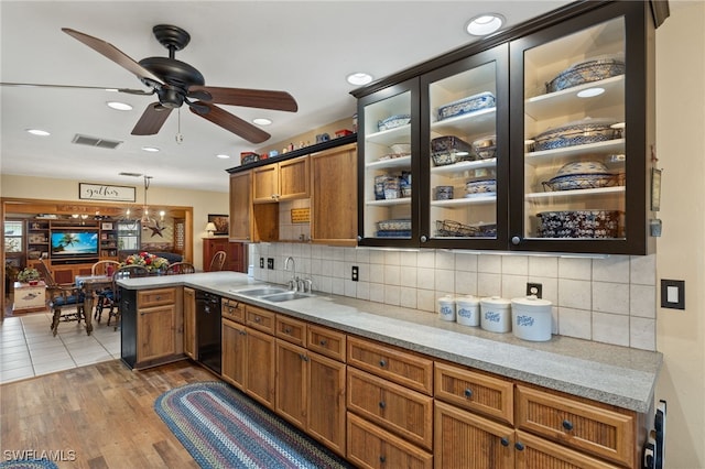 kitchen with light countertops, a sink, a peninsula, visible vents, and ceiling fan