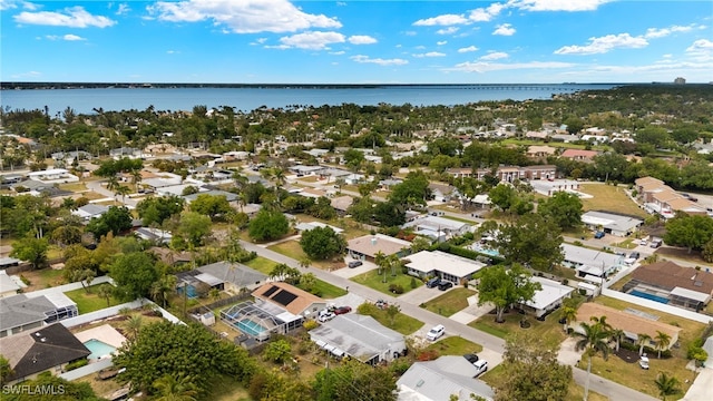 drone / aerial view featuring a residential view and a water view