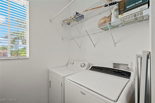 clothes washing area with washer and dryer and laundry area