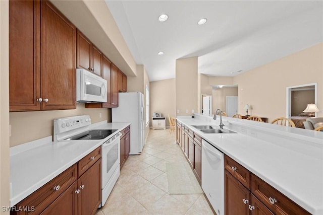 kitchen featuring light countertops, a sink, light tile patterned floors, white appliances, and recessed lighting