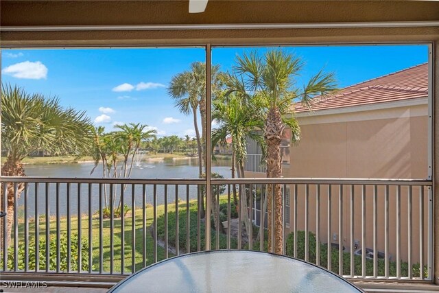 balcony featuring a water view and outdoor dining space