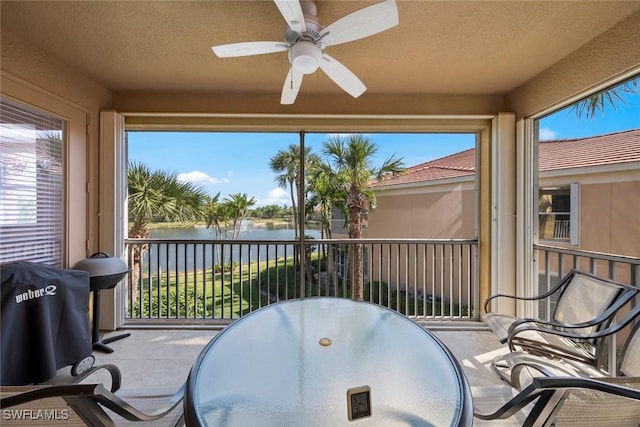 sunroom / solarium featuring a water view