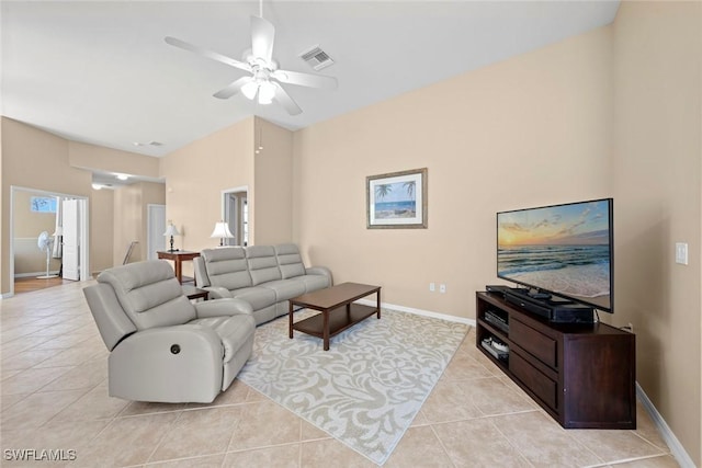 living area with a ceiling fan, light tile patterned floors, baseboards, and visible vents