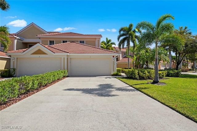 view of front facade with a tile roof, concrete driveway, stucco siding, an attached garage, and a front lawn