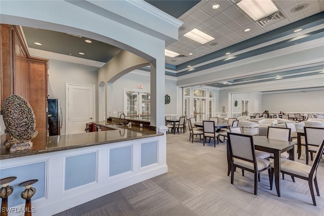 welcome area featuring arched walkways, visible vents, french doors, and a sink