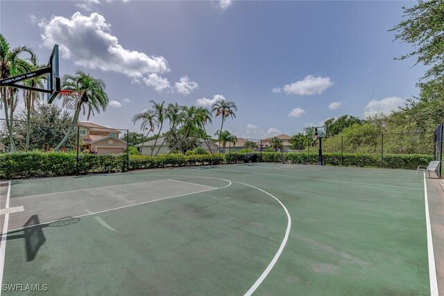 view of basketball court featuring fence and community basketball court