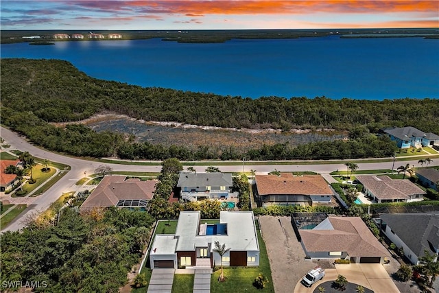 birds eye view of property featuring a residential view and a water view