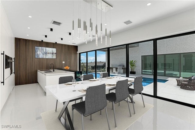 dining space featuring wooden walls, visible vents, and recessed lighting