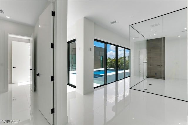 interior space featuring tile patterned flooring, visible vents, and recessed lighting