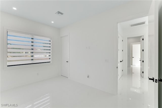 empty room with visible vents and recessed lighting