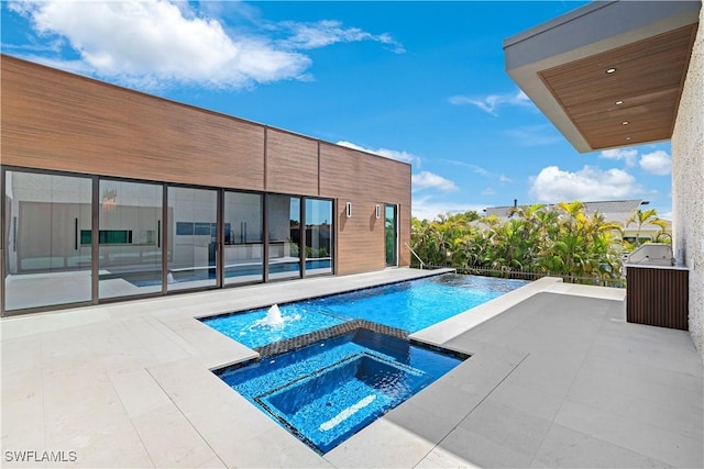 view of pool featuring a pool with connected hot tub and a patio