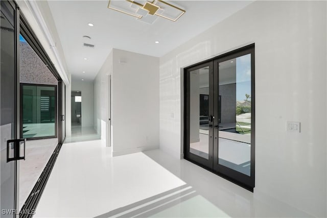 hall featuring french doors and recessed lighting