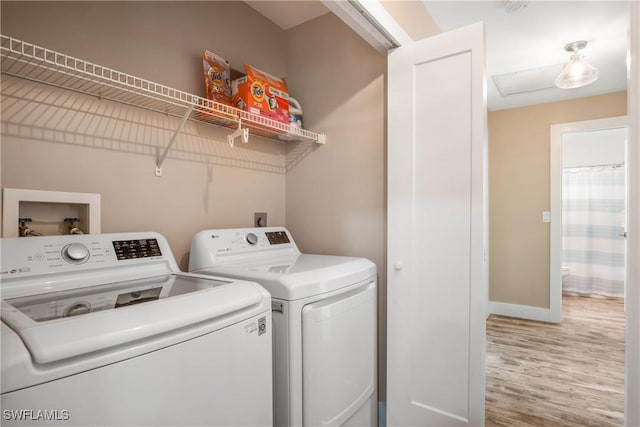 522 110th Ave N, Naples, FL 34108 - clothes washing area featuring washing machine and clothes dryer, wood finished floors, and baseboards