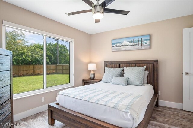522 110th Ave N, Naples, FL 34108 - bedroom featuring baseboards, wood finished floors, and ceiling fan
