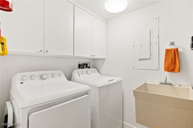4855 Dockside Dr Unit 204, Fort Myers, FL 33919 - laundry room with electric panel, washing machine and dryer, and cabinet space