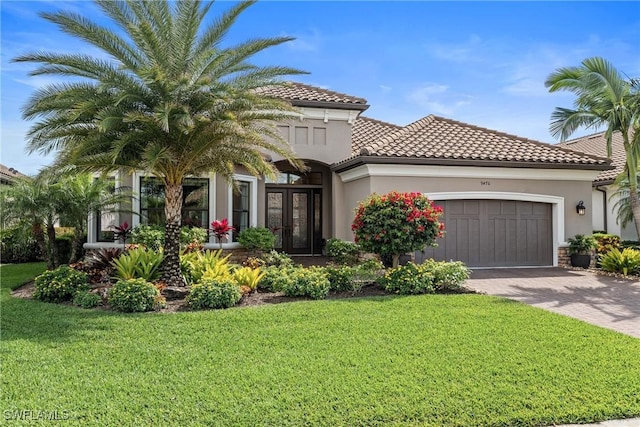 9476 Livorno Ct, Naples, FL 34119 - mediterranean / spanish house featuring french doors, a garage, a front lawn, decorative driveway, and a tile roof