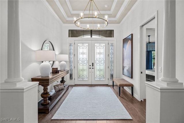 9476 Livorno Ct, Naples, FL 34119 - foyer entrance featuring french doors, decorative columns, crown molding, a chandelier, and dark wood-type flooring