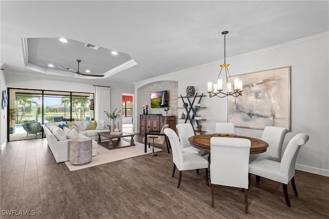 9476 Livorno Ct, Naples, FL 34119 - dining area featuring wood finished floors, a chandelier, a raised ceiling, crown molding, and recessed lighting