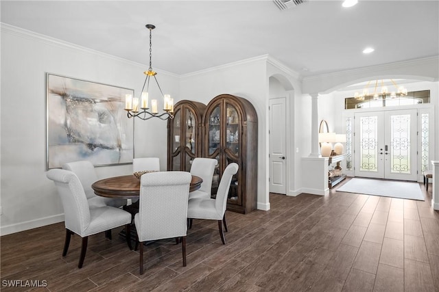 9476 Livorno Ct, Naples, FL 34119 - dining space with a chandelier, french doors, arched walkways, wood finished floors, and crown molding