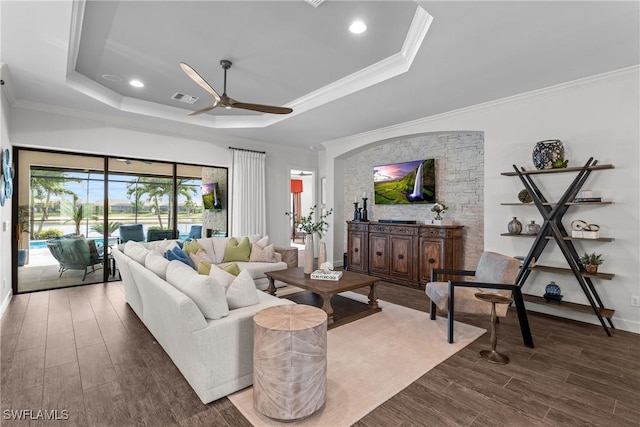 9476 Livorno Ct, Naples, FL 34119 - living area featuring a tray ceiling, ceiling fan, dark wood-style flooring, crown molding, and recessed lighting