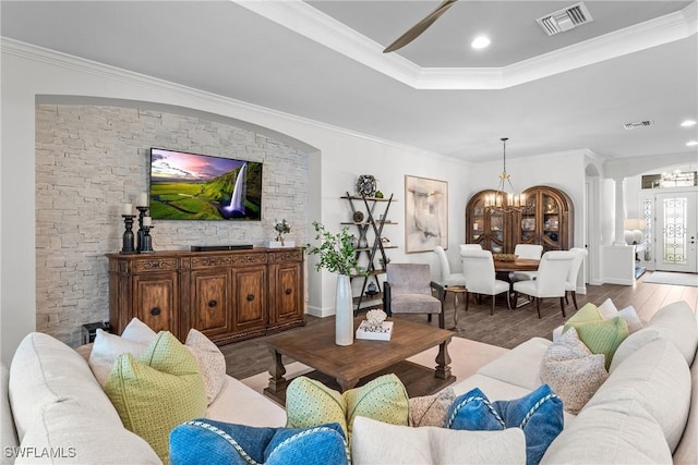 9476 Livorno Ct, Naples, FL 34119 - living area featuring a chandelier, ornamental molding, a tray ceiling, wood finished floors, and a ceiling fan