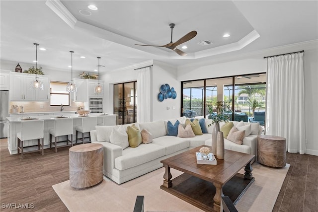 9476 Livorno Ct, Naples, FL 34119 - living area with healthy amount of natural light, ornamental molding, wood finished floors, a ceiling fan, and recessed lighting