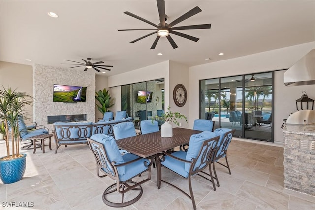 9476 Livorno Ct, Naples, FL 34119 - dining room featuring ceiling fan, an outdoor stone fireplace, and recessed lighting