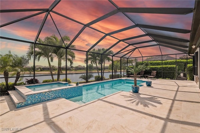 9476 Livorno Ct, Naples, FL 34119 - pool at dusk featuring a patio area, a water view, a pool with connected hot tub, and a lanai