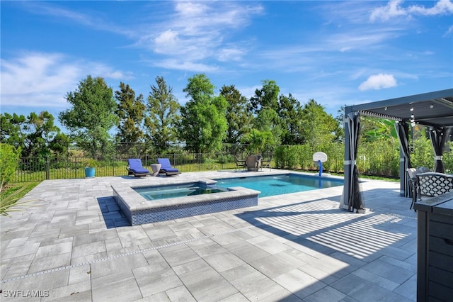 view of pool featuring a pool with connected hot tub, fence, and a patio area