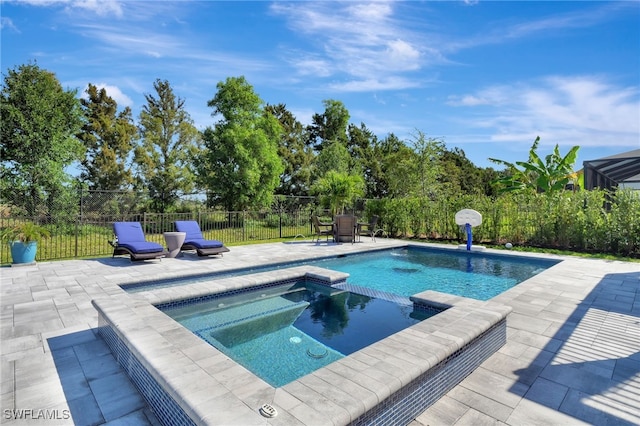 view of pool with a fenced backyard, a pool with connected hot tub, and a patio area